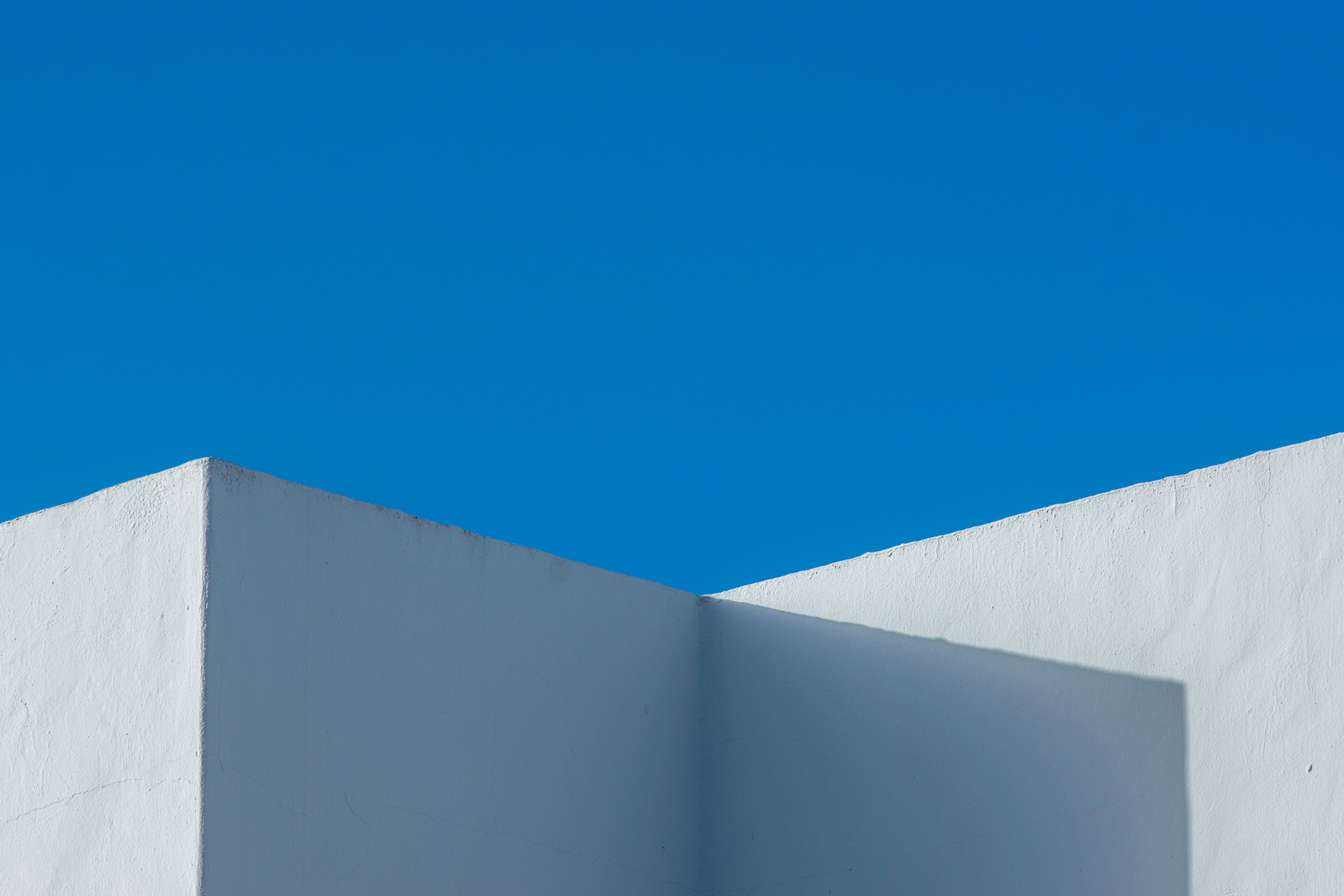 Whitewashed architectural volume photographed against an open sky
